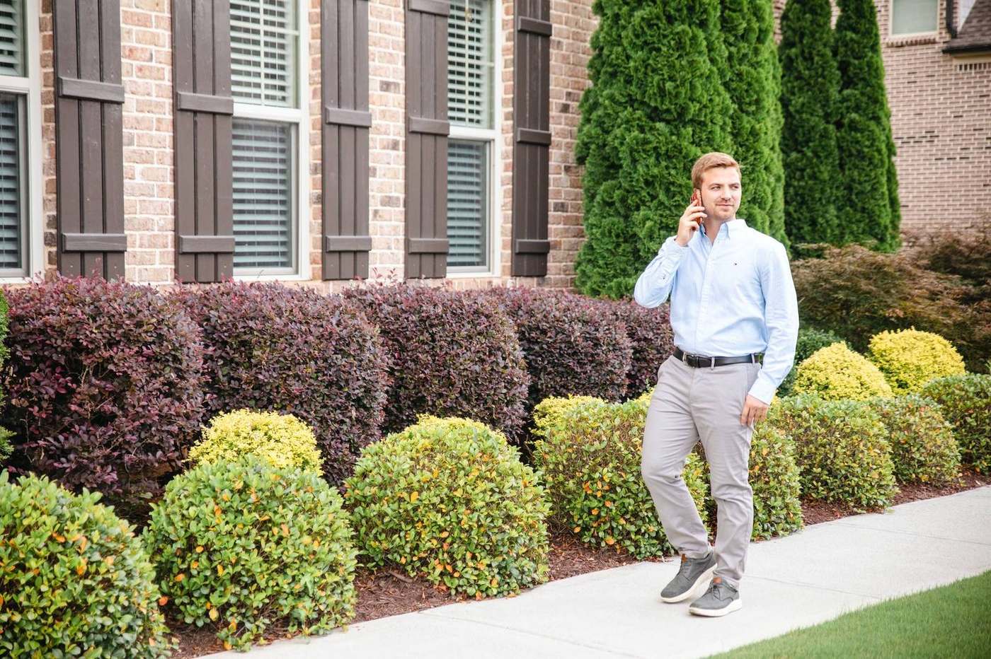 Connor Heriot, REALTOR with eXp Realty, on the phone outside a North Georgia home