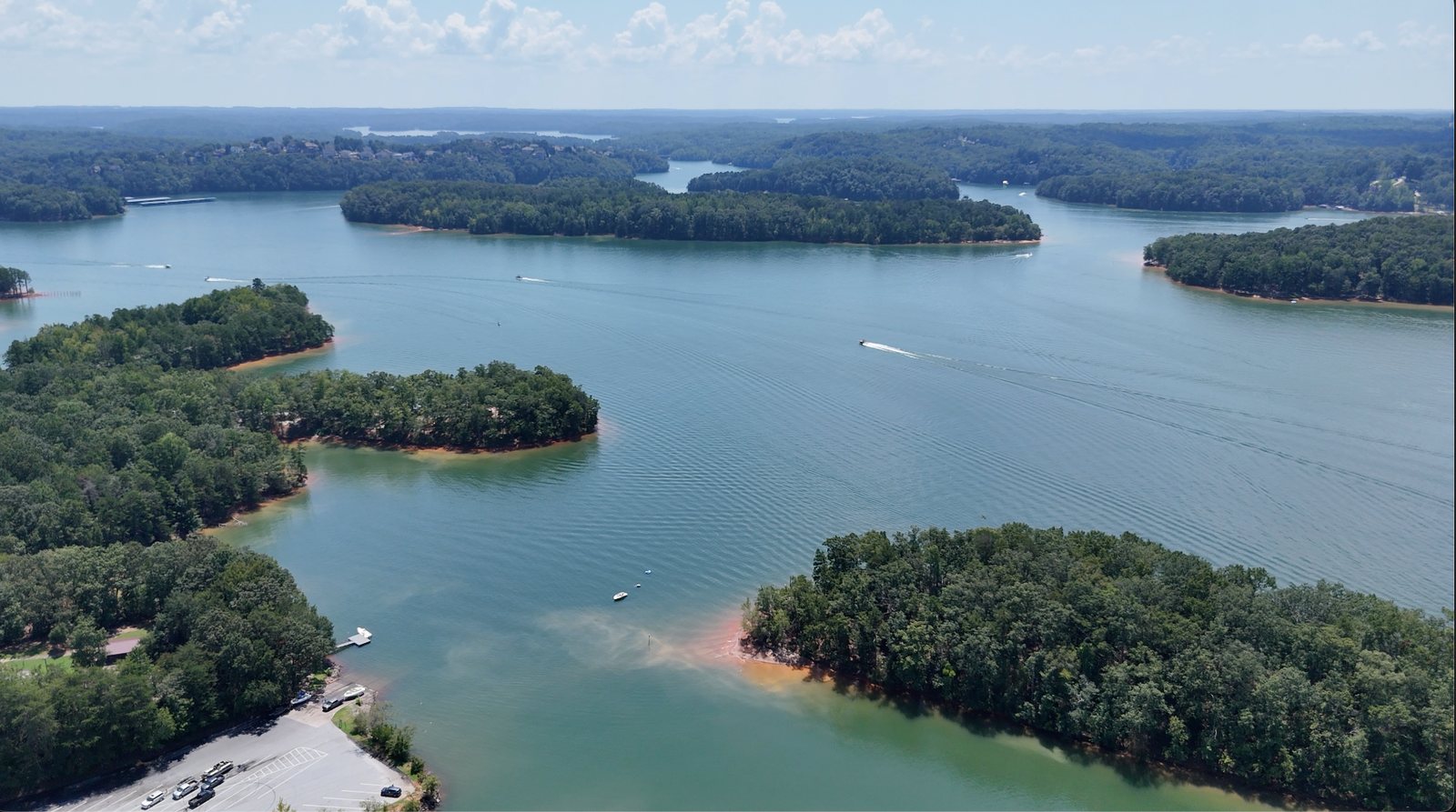 Aerial view of Lake Lanier with wooded coves and boats