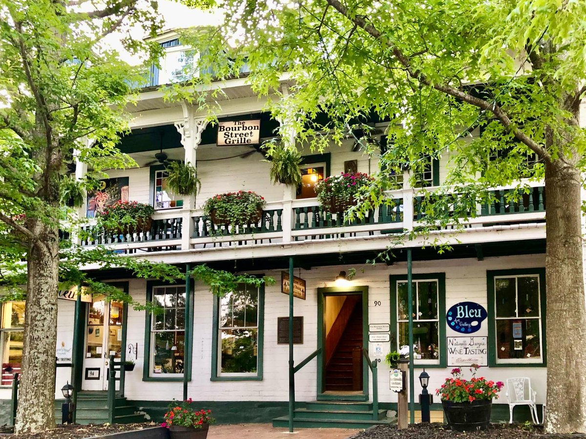 A historic two-story building with wraparound porches on the Dahlonega square, home to the Bourbon Street Grille